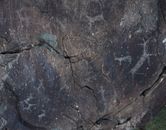 From above of dark gray natural slope with shabby surface and tiny aged paintings