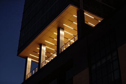 Free A contemporary building facade with illuminated interior sections, captured at night in Boston, MA. Stock Photo
