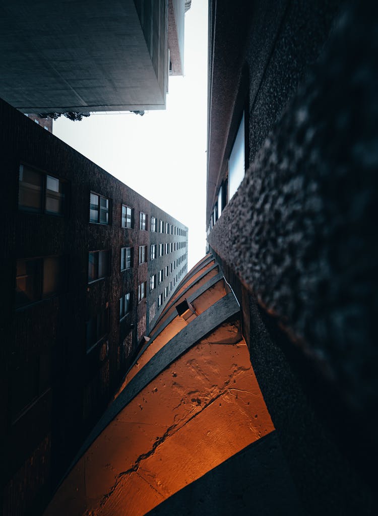 Looking Up Past Concrete Building At Sky