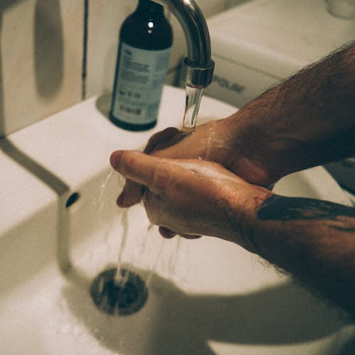 A Person Washing his Hands