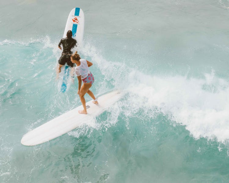 Man And Woman Surfing