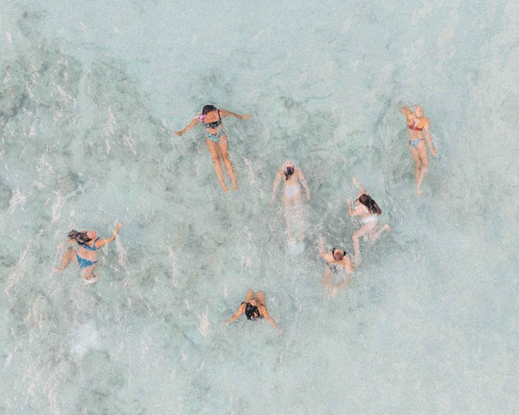 Group Of Women Swimming In The Beach