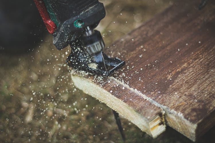 Close-up Of Scroll Saw Cutting Wood