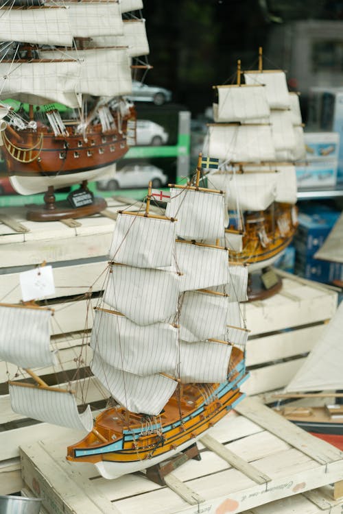 From above of handcraft wooden miniature of sailing ship in showcase of souvenir store