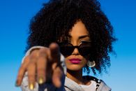 Crop arrogant black woman pointing at camera