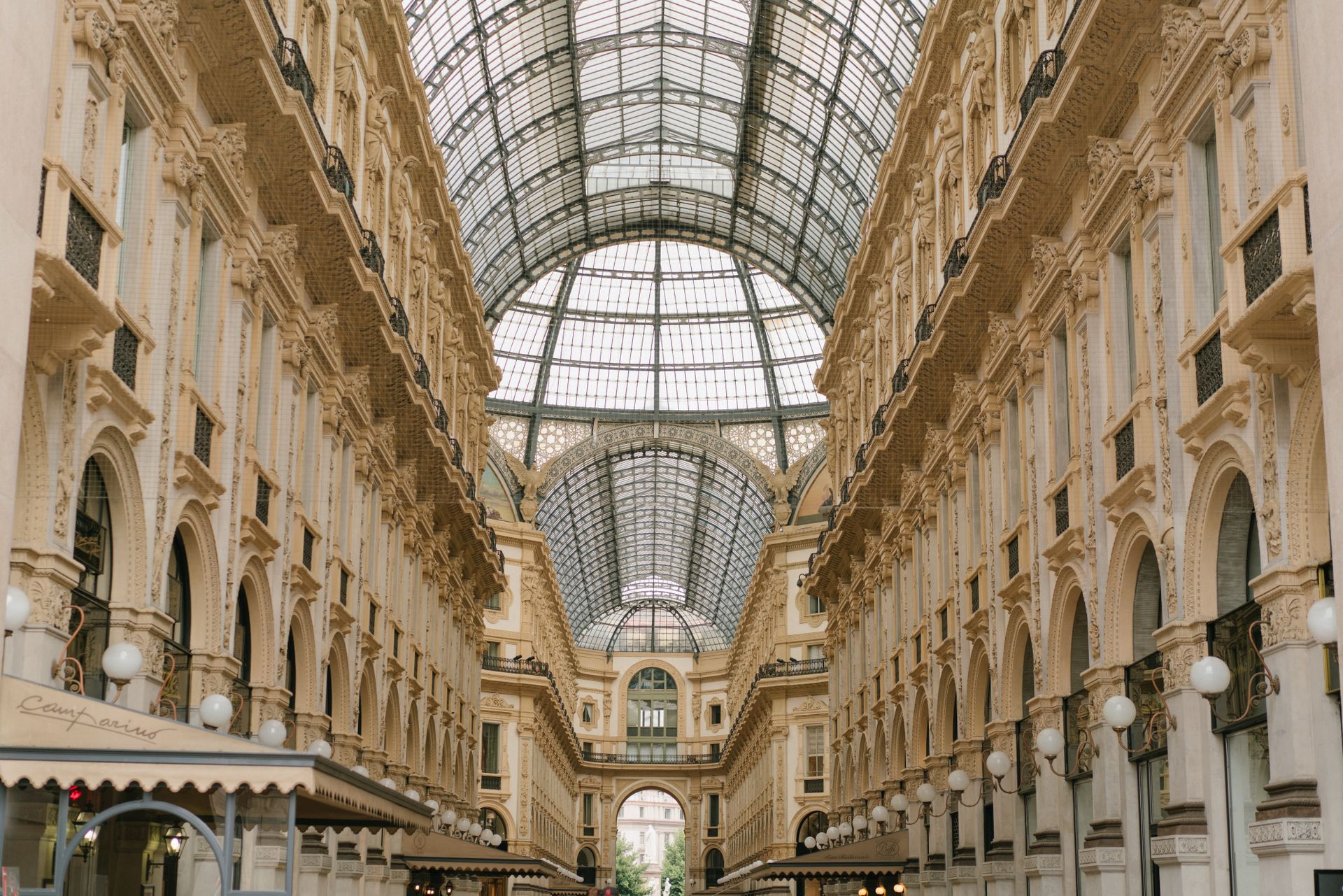 Interior of Galleria Dallas shopping center with ornate classical architecture, glass skylight ceiling, and elegant corridor lined with storefronts