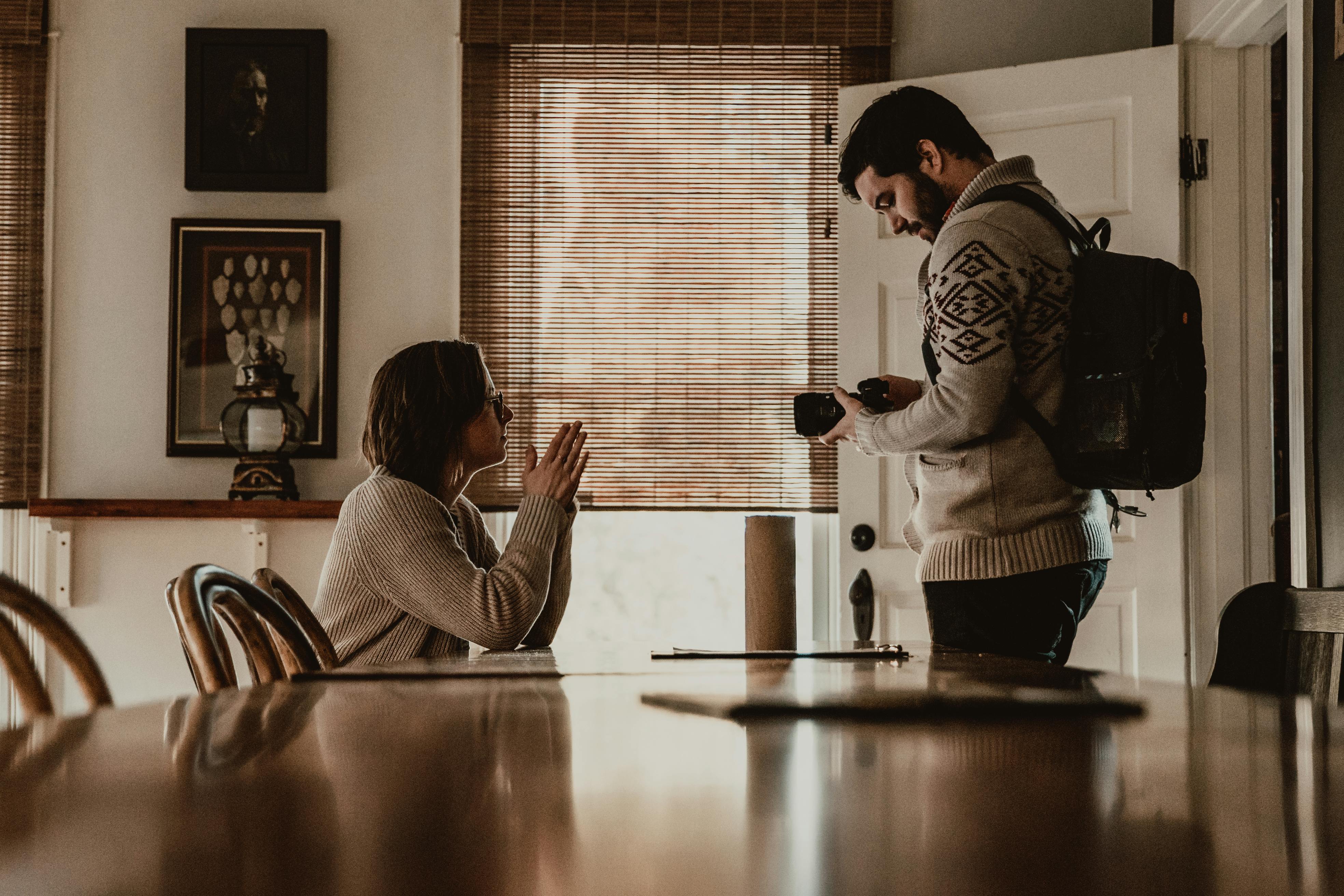 young couple with photo camera in modern dining room