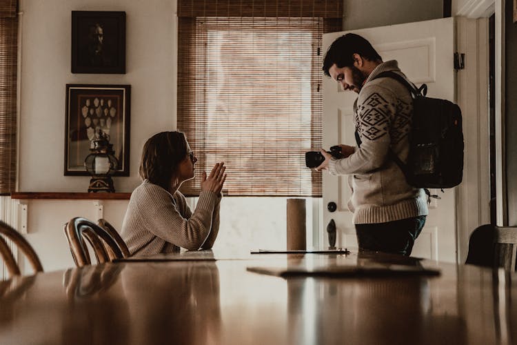 Young Couple With Photo Camera In Modern Dining Room