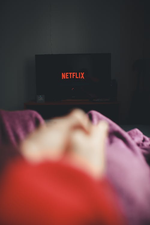 Free Vertical Shot of Watching Netflix on TV  Stock Photo