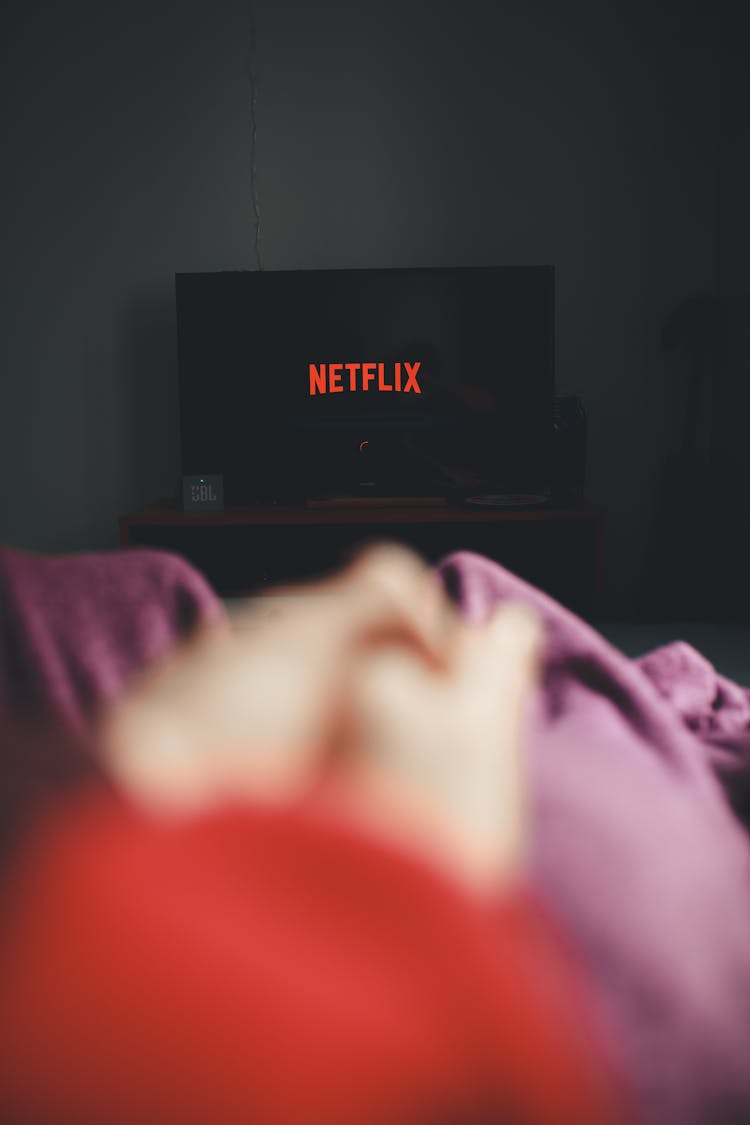 Vertical Shot Of Watching Netflix On TV 