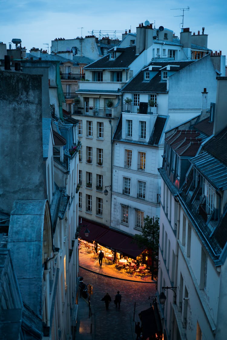 Evening Street With Outdoor Cafe In Paris