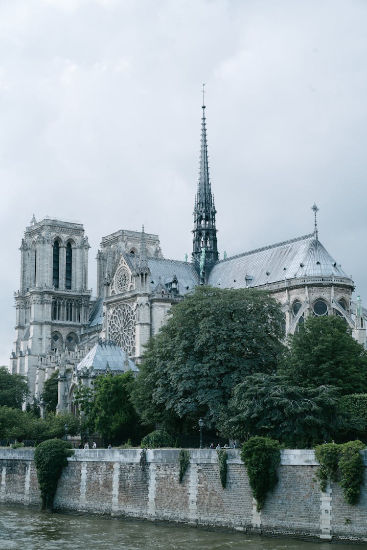 Notre Dame De Paris In Greenery On Cloudy Day