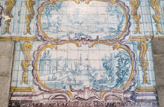 Amazing Azulejo tin glazed ceramic tilework depicting pastoral scene and ship in port on wall of building in Porto city in Portugal