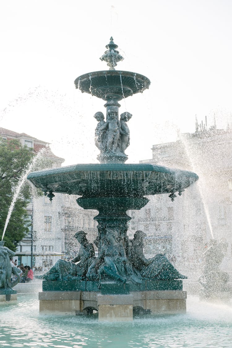 Bronze Fountain On Rossio Square In Lisbon On Fine Day