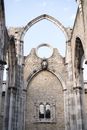 Element of ruined main nave of Convent of Lady of Mount Carmel with pointed gothic stone arch and ornate window on fine summer day