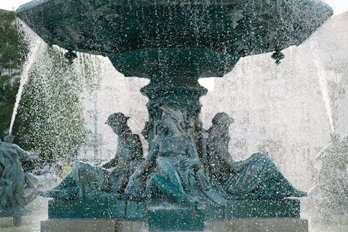 Bronze sculptures on base of fountain on Rossio Square