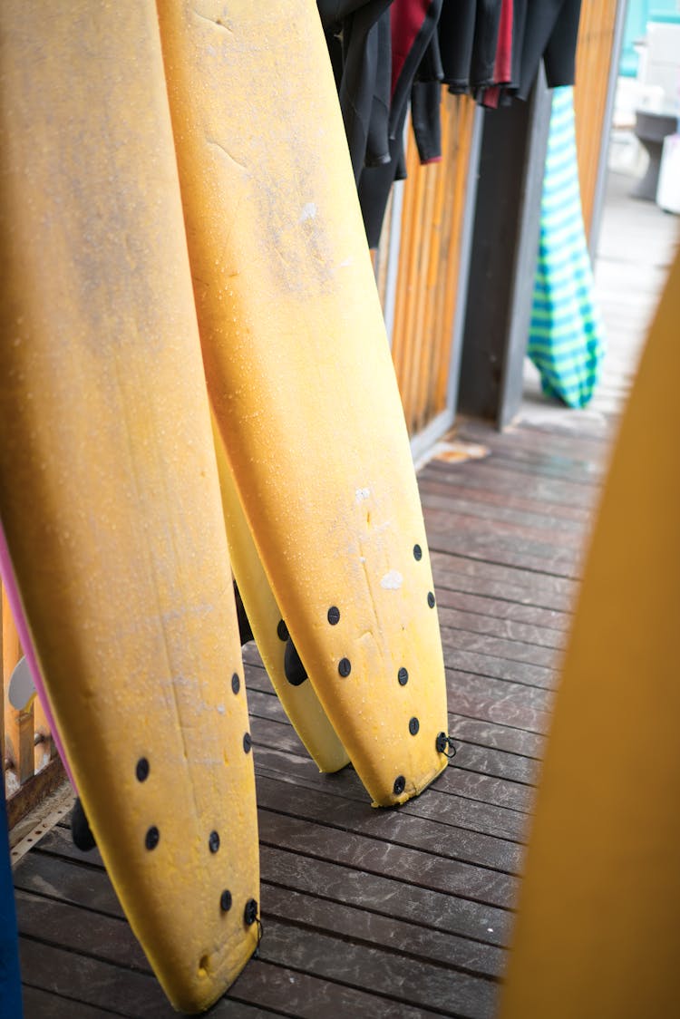 Surfboards And Wetsuits At Entrance Of Change Room