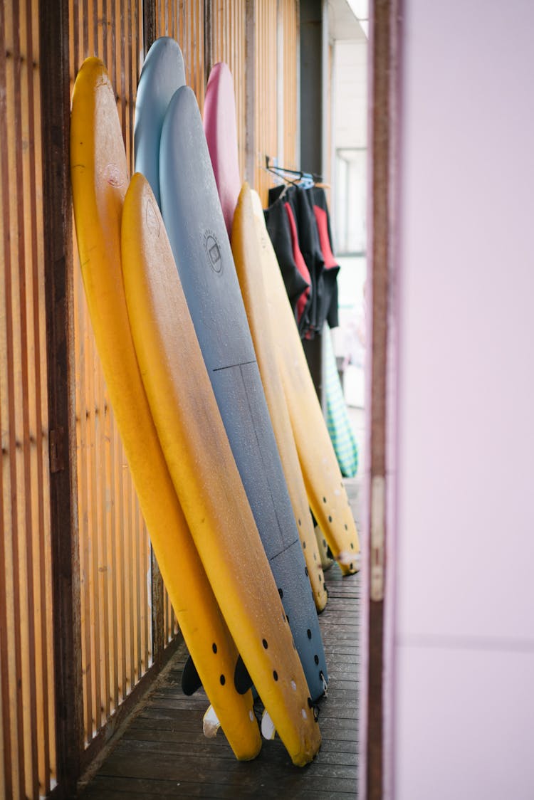 Colorful Surfing Boards Leaning Against Wall In Beach Change Room