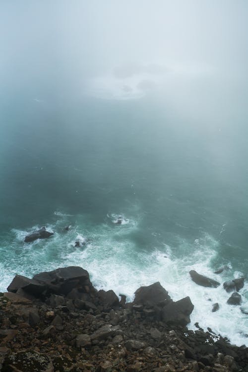 Foamy waves crashing into rocky cliff