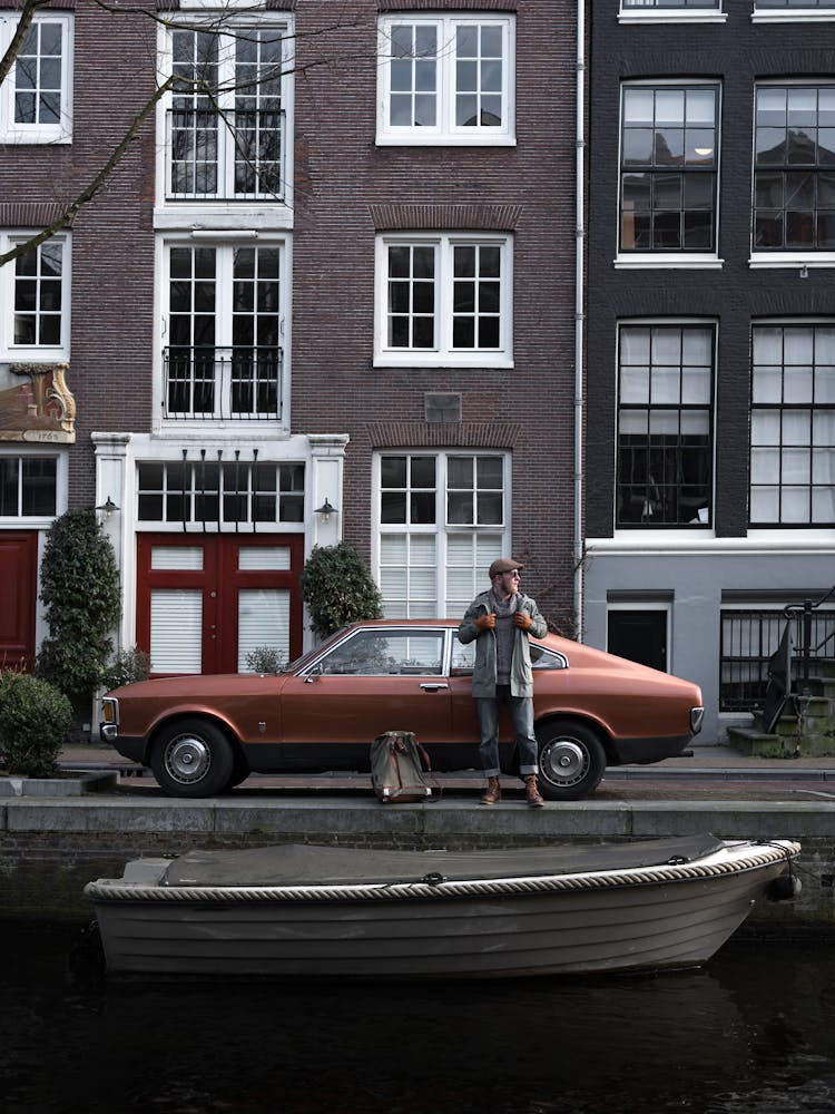 Man And Retro Car Parked Near City Canal