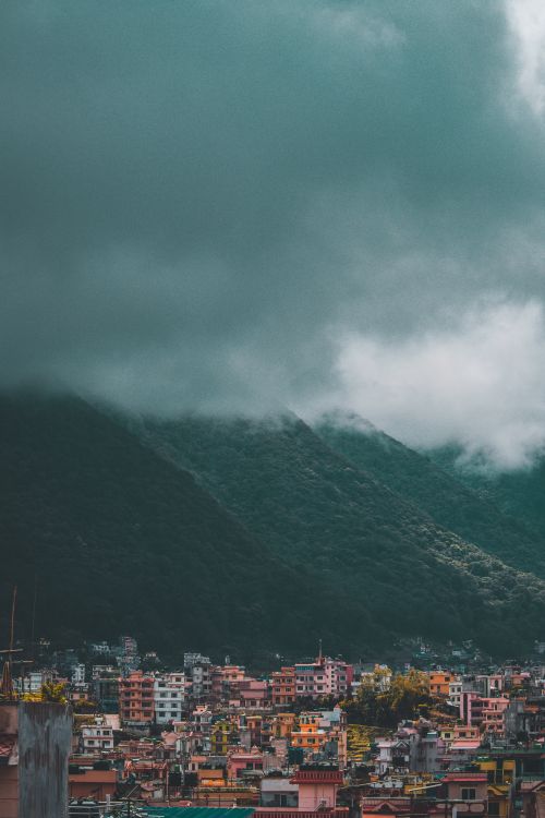 Free A serene mist-covered mountain city view of Tarakeshwar, Nepal. Stock Photo