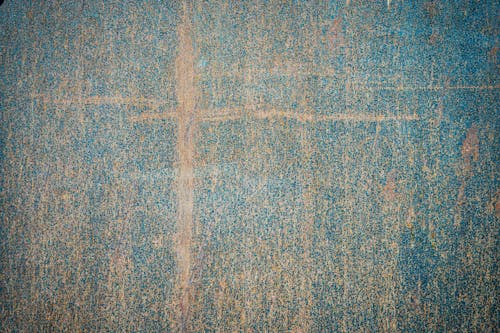 Top view of painted weathered surface with damaged patterns and scratches as abstract background