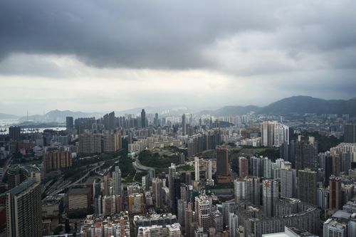 Free Aerial panoramic view of Kowloon's urban skyline under an overcast sky in Hong Kong. Stock Photo