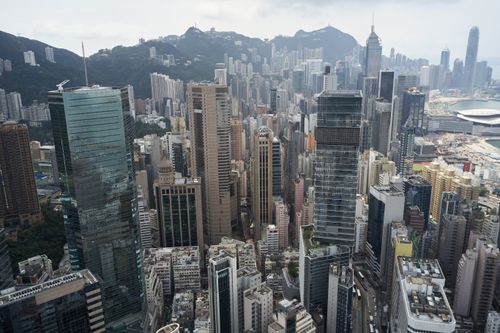 Free Aerial view of the bustling modern skyline in Hong Kong Island with skyscrapers and mountains. Stock Photo