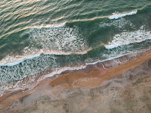 Drone Shot of Ocean Waves Crashing on Shore