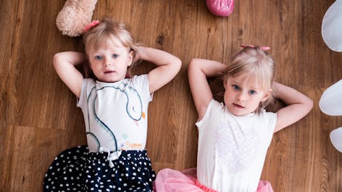 Free Little kids lying on floor together Stock Photo