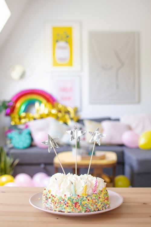Free Brightly decorated birthday cake with star toppers in a festive indoor setting. Stock Photo