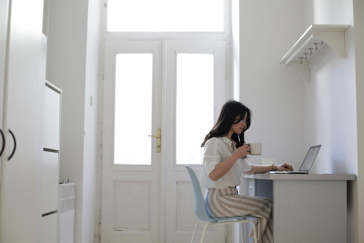 Asian freelancer working from home on a laptop