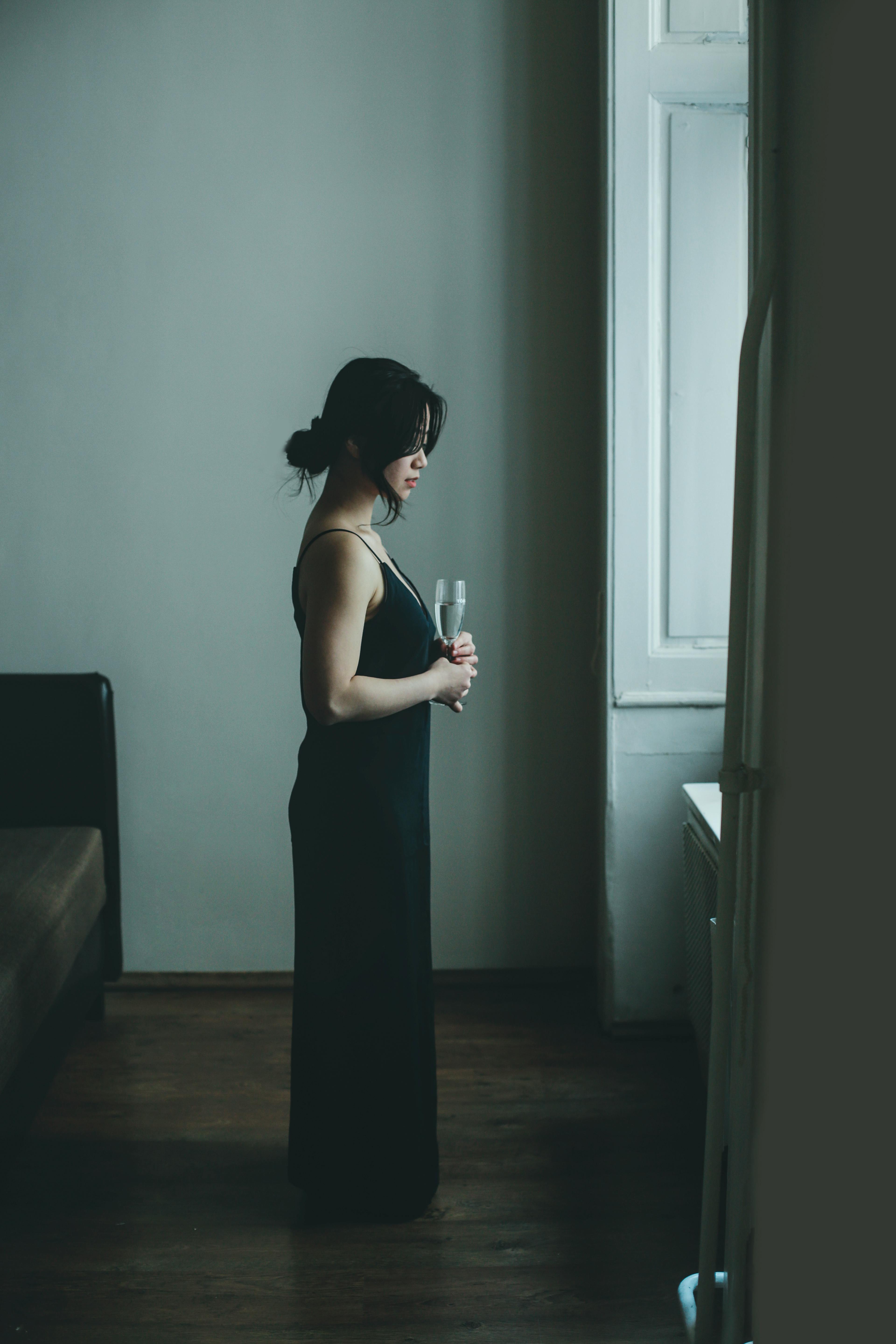 elegant asian woman with wine at home