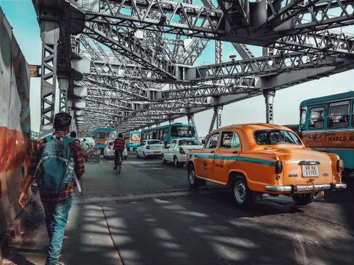 Free Vibrant street scene on Howrah Bridge with traffic and pedestrians in Kolkata, India. Stock Photo