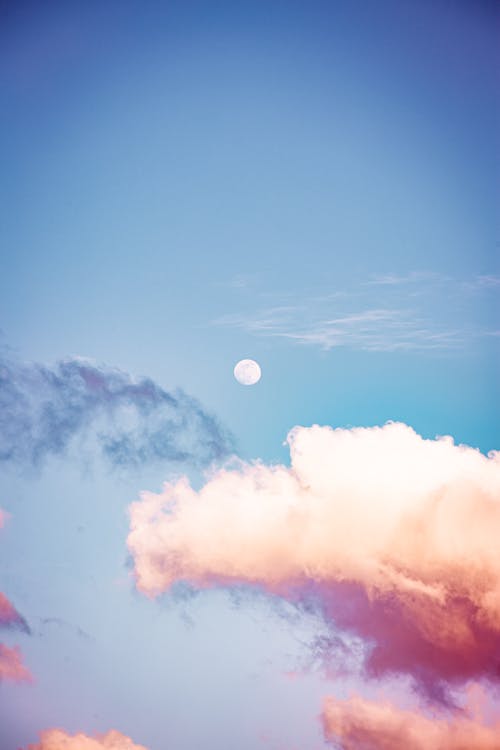 Moon in blue cloudy sky