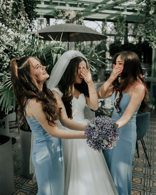 Free Bride Holding Bouquet of Flowers with her Bridesmaids Stock Photo