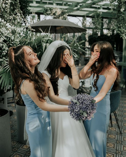 Bride Holding Bouquet of Flowers with her Bridesmaids