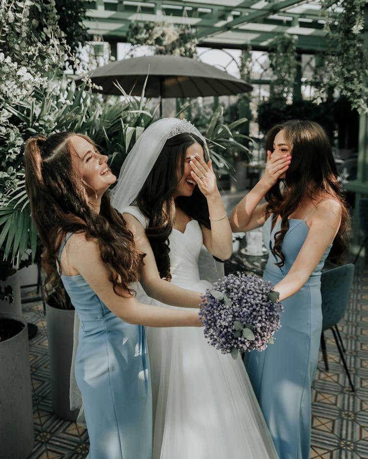 Bride Holding Bouquet Of Flowers With Her Bridesmaids