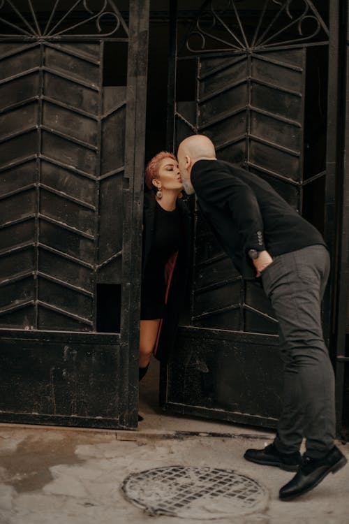 Adult romantic couple kissing in doorway