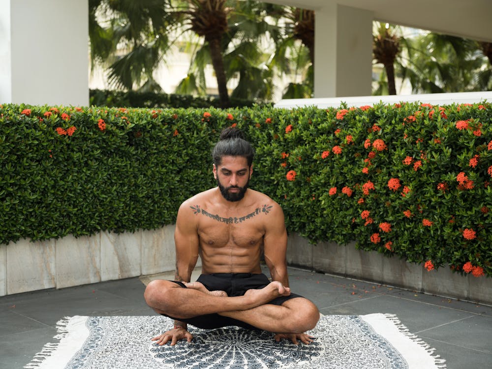 Free Photo of Man in Black Shorts Doing Yoga Stock Photo