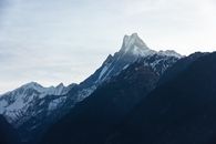 Black and White Mountains Under White Clouds