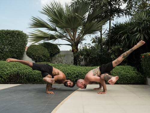 Photo of Two Men Doing Yoga