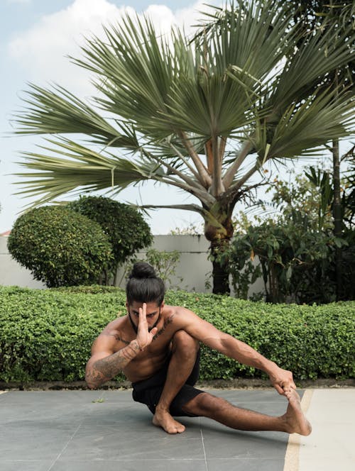 Free Photo of Man in Black Shorts Doing Yoga Stock Photo