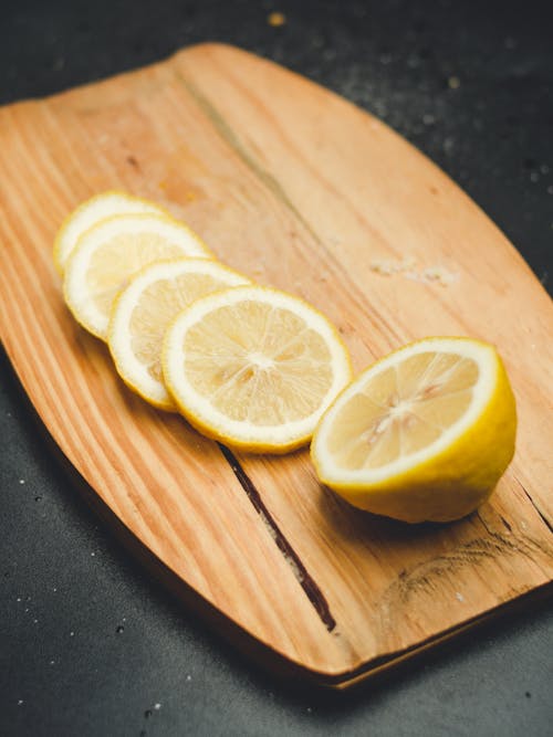 Sliced Lemon on Brown Wooden Chopping Board