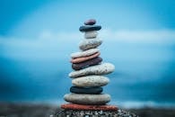 Stack of colorful pebbles near blue sea