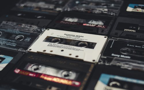 One transparent compact audio cassette with visible tape and red