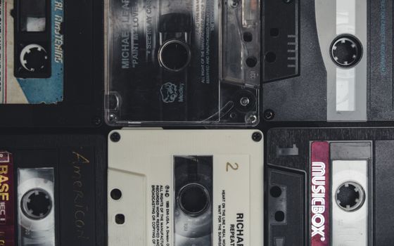 Close-up view of old cassette tapes, showcasing a nostalgic retro feel.
