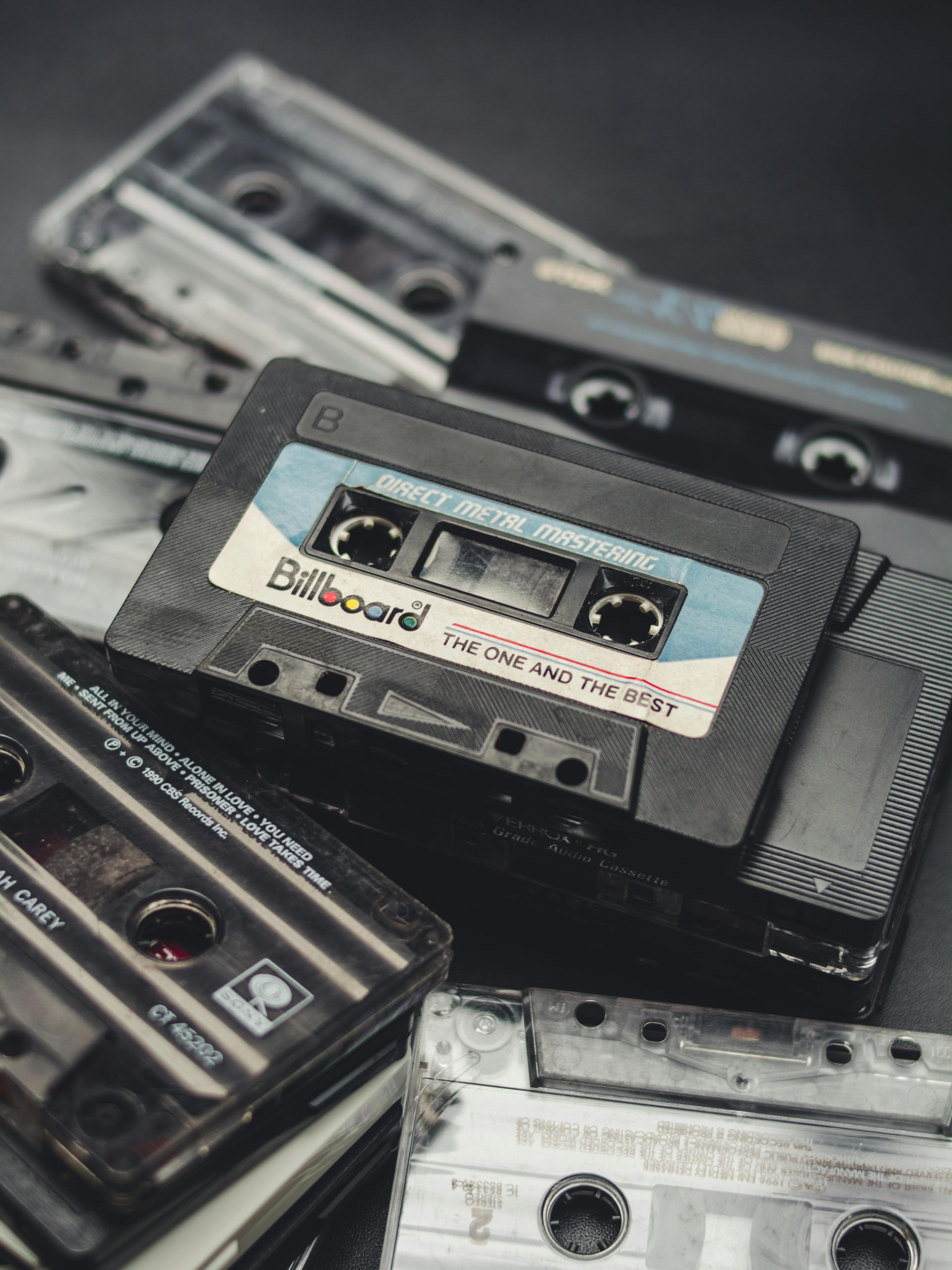 Premium Photo  Ready to kick it retro style. a studio shot of three men  clad in retro 70s wear holding a cassette player.