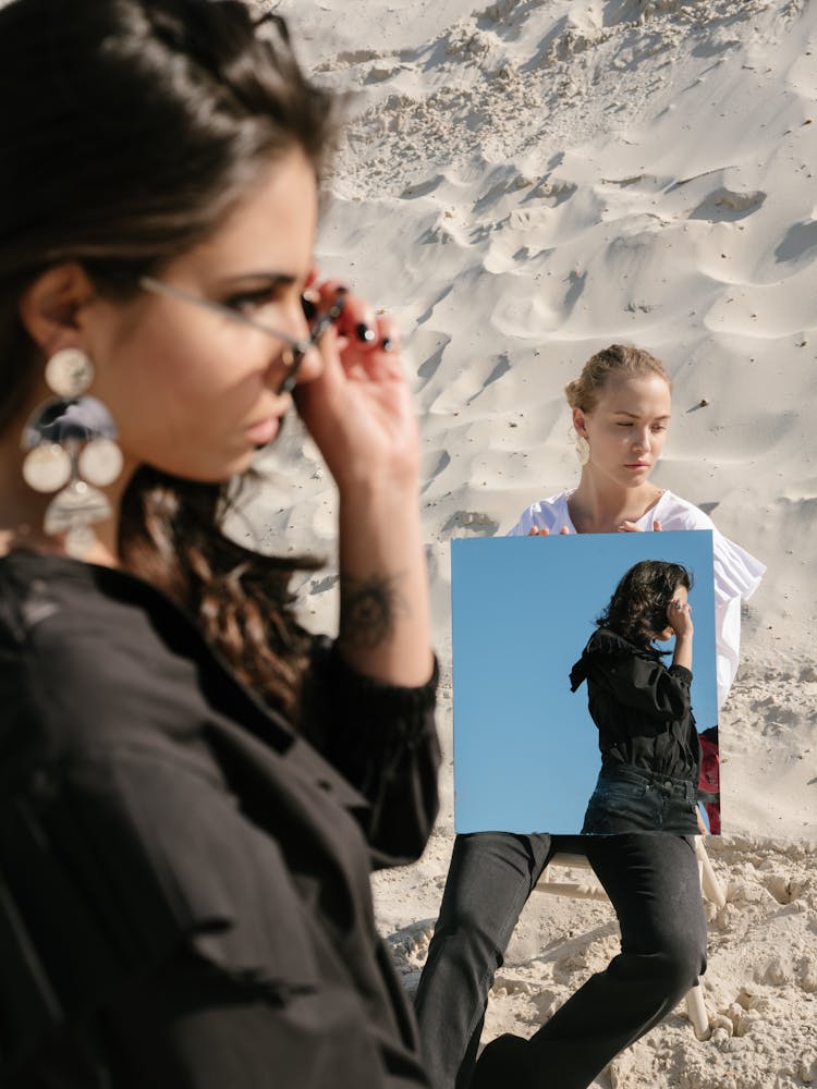 Young Female Rivals With Square Mirror On Sandy Beach Under Sunlight