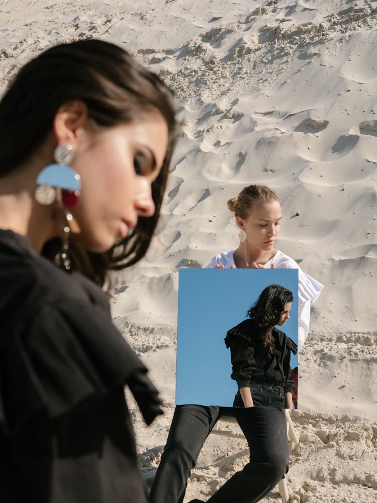 Young Female Rivals With Square Mirror On Sandy Beach During Daytime